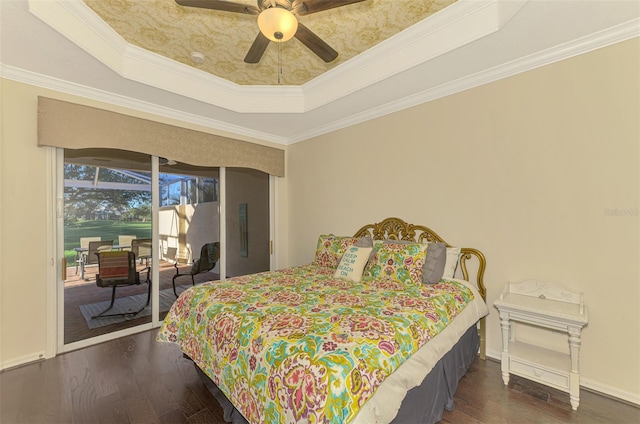 bedroom with a raised ceiling, ceiling fan, dark hardwood / wood-style flooring, and ornamental molding