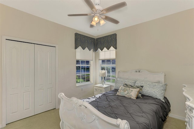 carpeted bedroom with ceiling fan and a closet