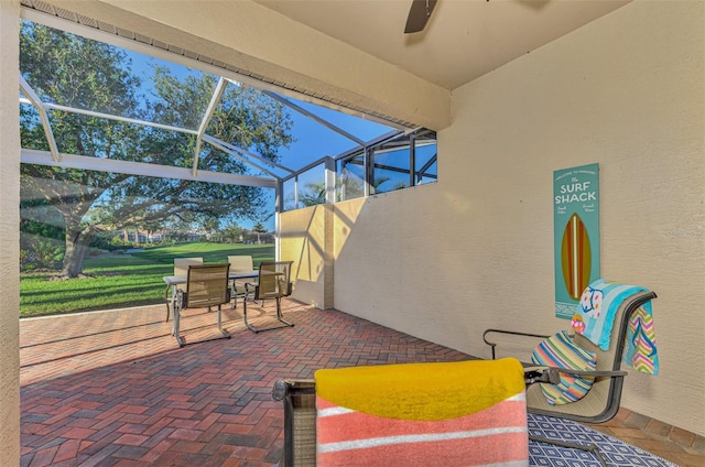 view of patio with ceiling fan and a lanai