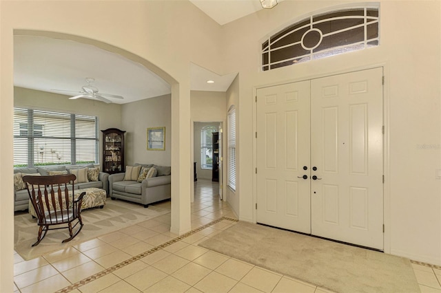 foyer with ceiling fan and light tile patterned floors