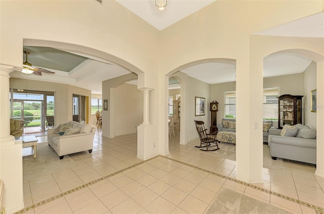 interior space featuring decorative columns and ceiling fan