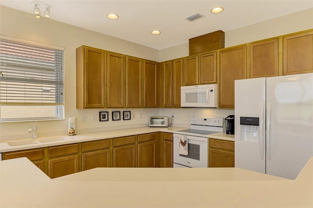 kitchen featuring sink and white appliances