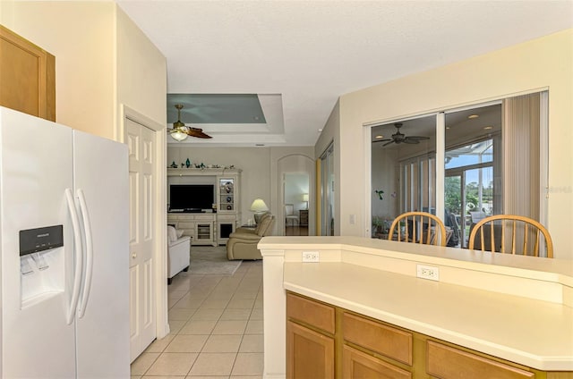 kitchen with white refrigerator with ice dispenser, a textured ceiling, and light tile patterned flooring