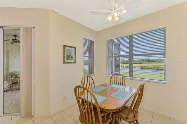 tiled dining room featuring plenty of natural light and ceiling fan