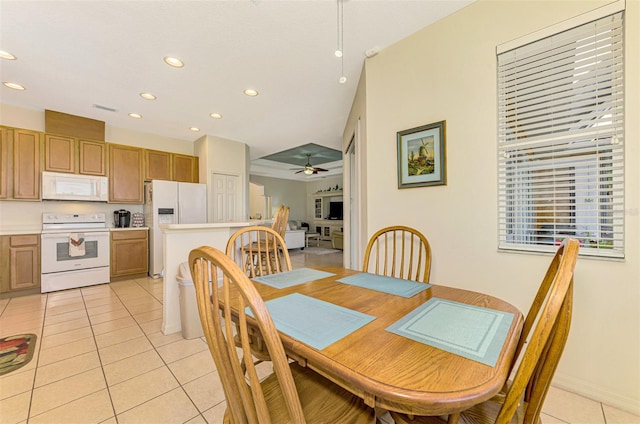 dining area with ceiling fan and light tile patterned floors