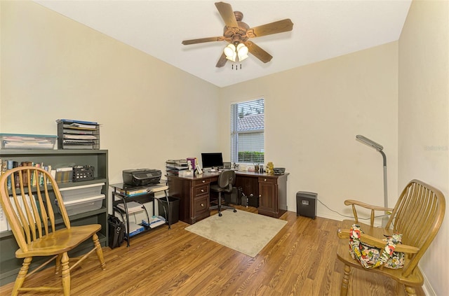 home office with light hardwood / wood-style flooring and ceiling fan