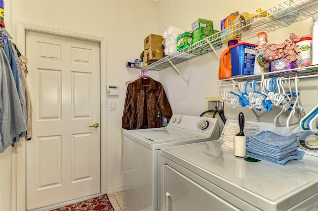 laundry room featuring tile patterned flooring and washer and dryer