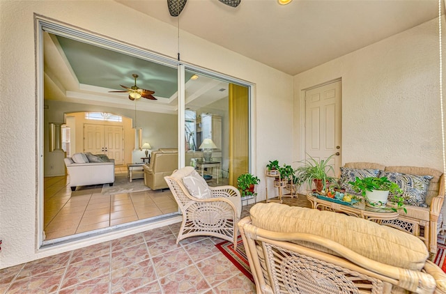 sunroom with ceiling fan