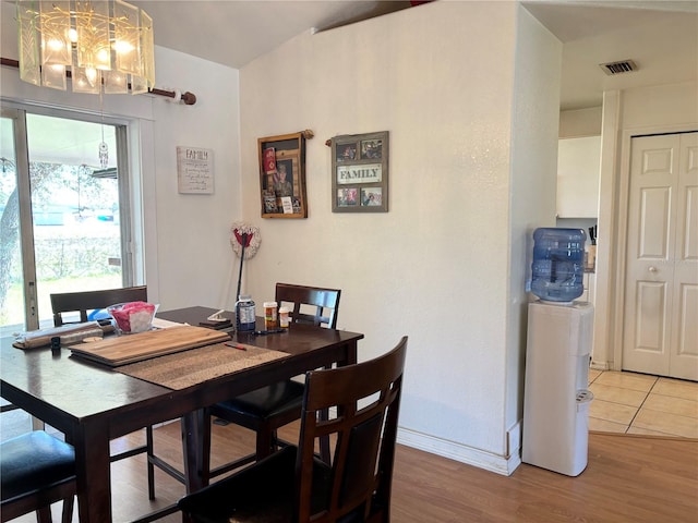 dining area with a chandelier and wood-type flooring