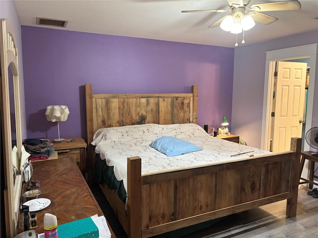 bedroom featuring hardwood / wood-style flooring and ceiling fan