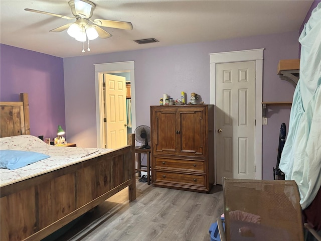 bedroom with ceiling fan and light hardwood / wood-style flooring