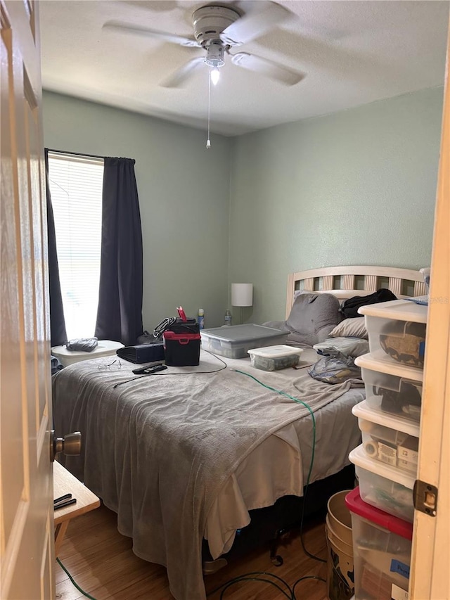 bedroom with hardwood / wood-style floors and ceiling fan