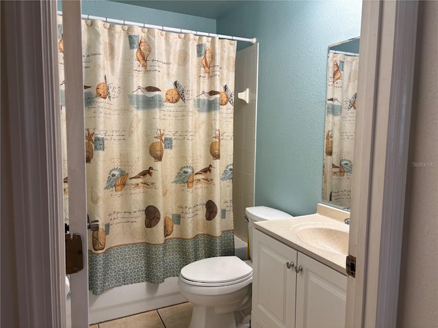 full bathroom featuring tile patterned floors, vanity, toilet, and shower / bath combo with shower curtain