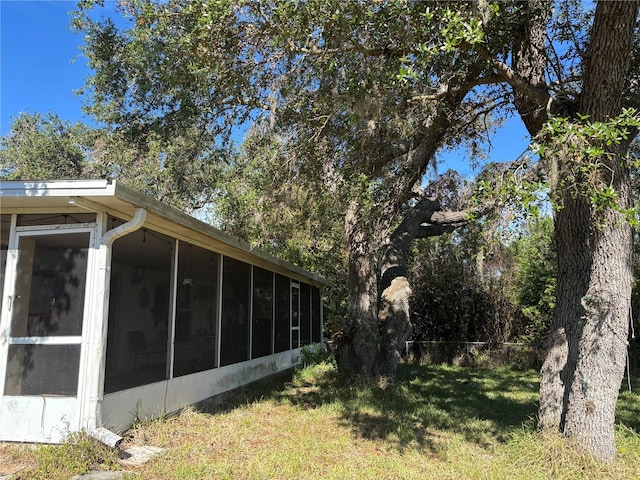 exterior space featuring a sunroom and a yard