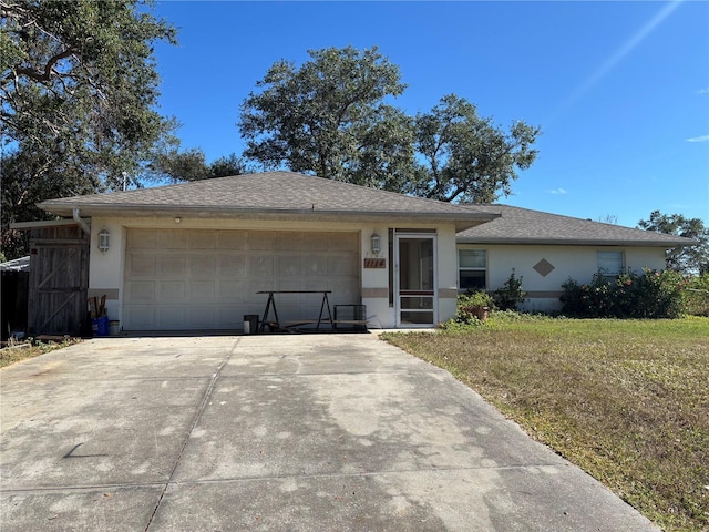 single story home with a front lawn and a garage