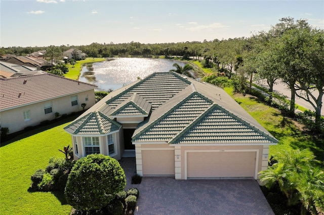 view of front of home with a water view and a garage