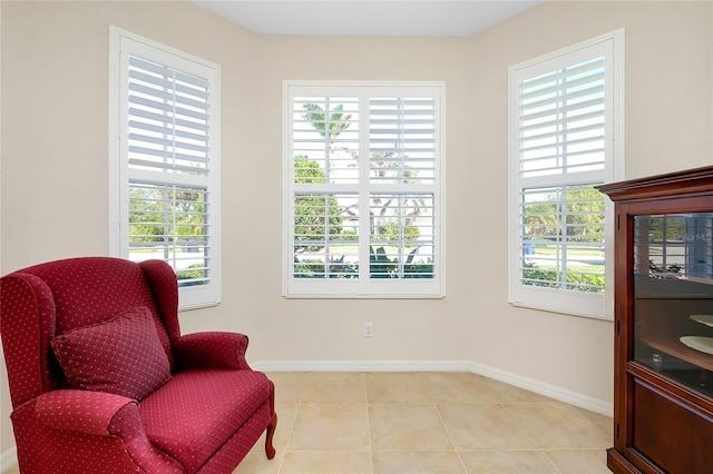 sitting room with a wealth of natural light and light tile patterned flooring