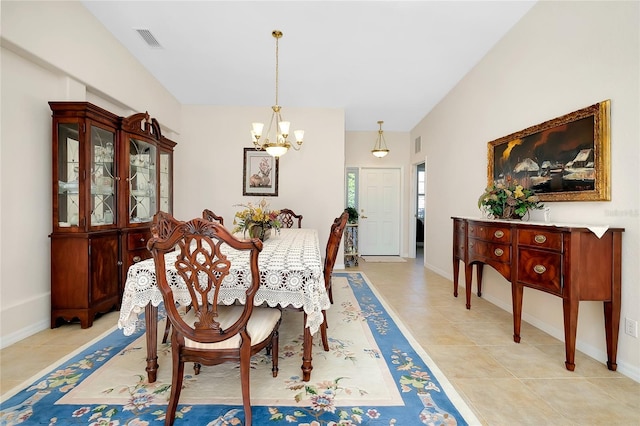 tiled dining space featuring a notable chandelier