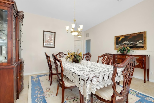 dining room featuring light tile patterned flooring and a chandelier