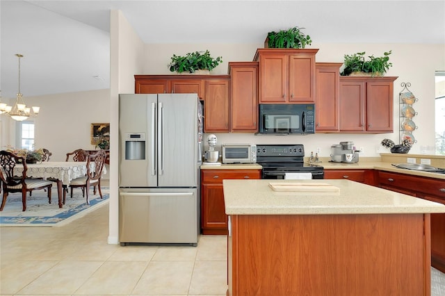 kitchen featuring a chandelier, lofted ceiling, decorative light fixtures, light tile patterned floors, and black appliances