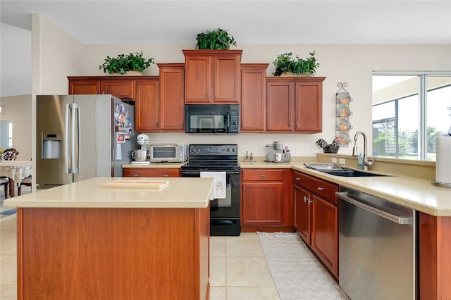 kitchen with light stone countertops, sink, kitchen peninsula, light tile patterned floors, and black appliances