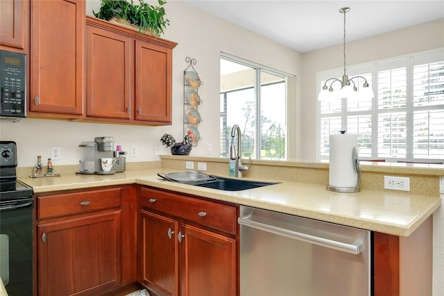 kitchen with black appliances, sink, a wealth of natural light, and an inviting chandelier