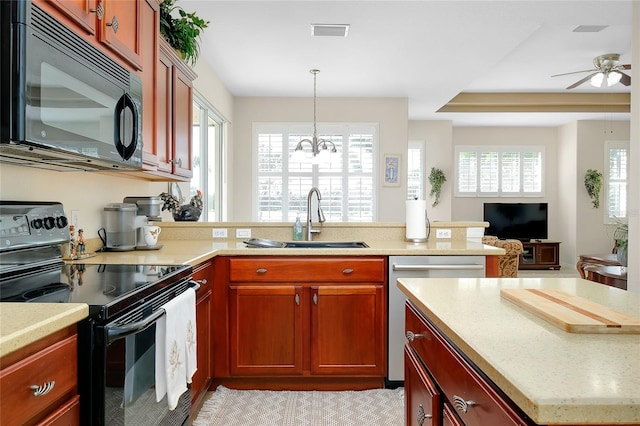 kitchen featuring black appliances, ceiling fan with notable chandelier, sink, and hanging light fixtures