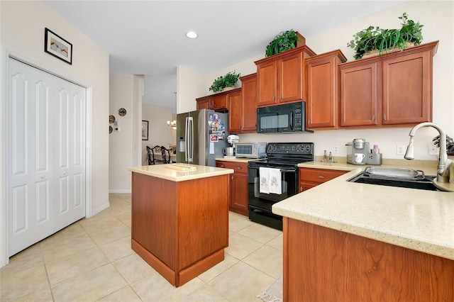 kitchen with light stone countertops, sink, black appliances, light tile patterned floors, and a kitchen island