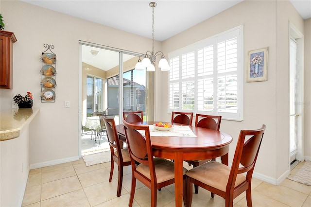 dining area featuring light tile patterned floors and a chandelier