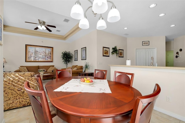 tiled dining room with sink and ceiling fan with notable chandelier