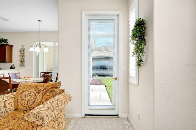 entryway featuring a chandelier and a wealth of natural light