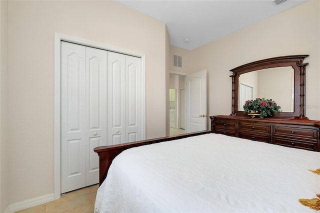 tiled bedroom with a closet