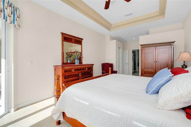 tiled bedroom featuring ceiling fan and a raised ceiling