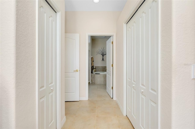 corridor featuring light tile patterned floors