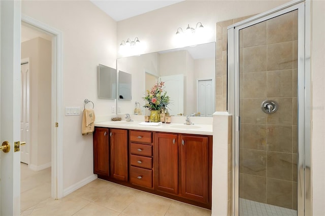 bathroom with tile patterned floors, a shower with door, and vanity