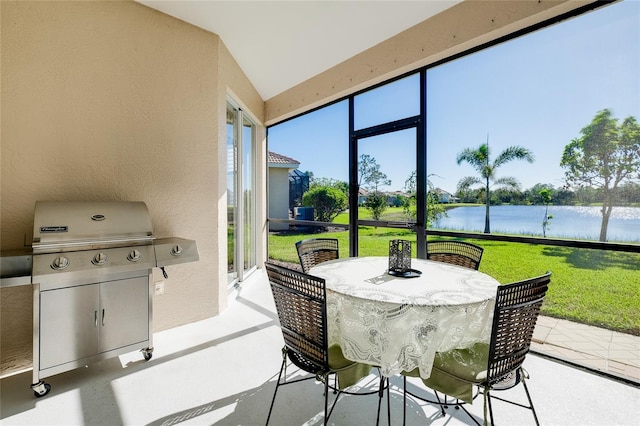 sunroom with a water view and lofted ceiling