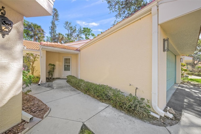 606 Marcus St Unit 26, Venice, FL 34285 - entrance to property with stucco siding, a garage, and a tile roof