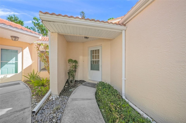 606 Marcus St Unit 26, Venice, FL 34285 - view of exterior entry with stucco siding and a tiled roof