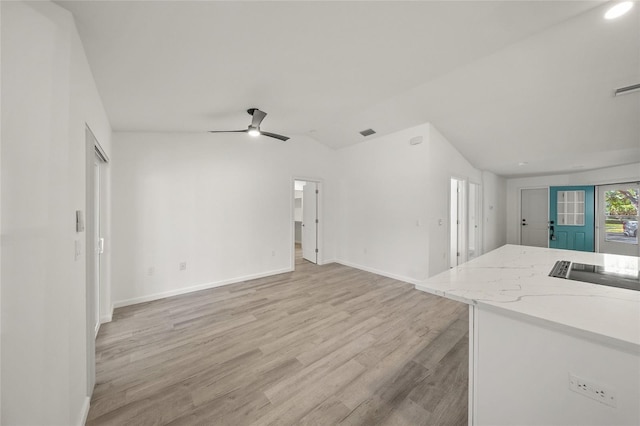 unfurnished living room with ceiling fan, light hardwood / wood-style floors, and lofted ceiling