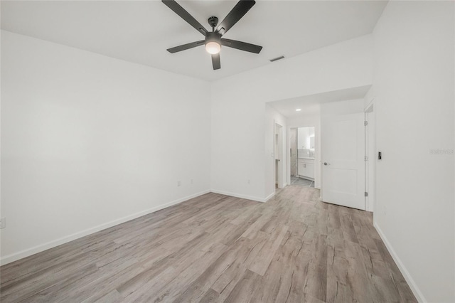 spare room featuring light wood-type flooring and ceiling fan