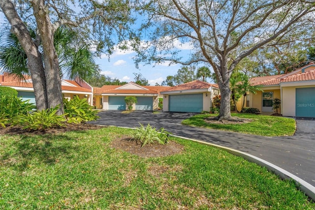 view of front of home featuring a garage and a front lawn