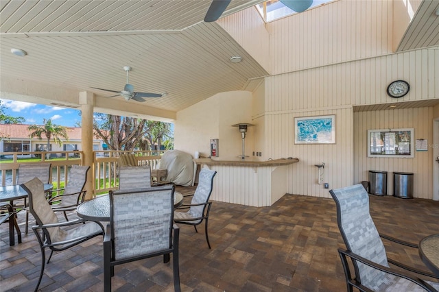 view of patio featuring an outdoor bar and ceiling fan