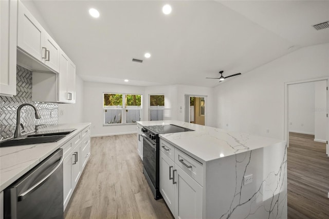 kitchen with white cabinetry, sink, stainless steel dishwasher, and electric range