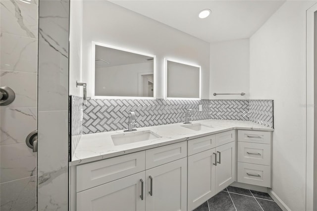 bathroom with tile patterned flooring, decorative backsplash, a shower, and vanity