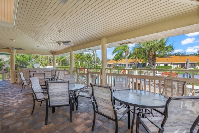 view of patio / terrace featuring ceiling fan and a water view