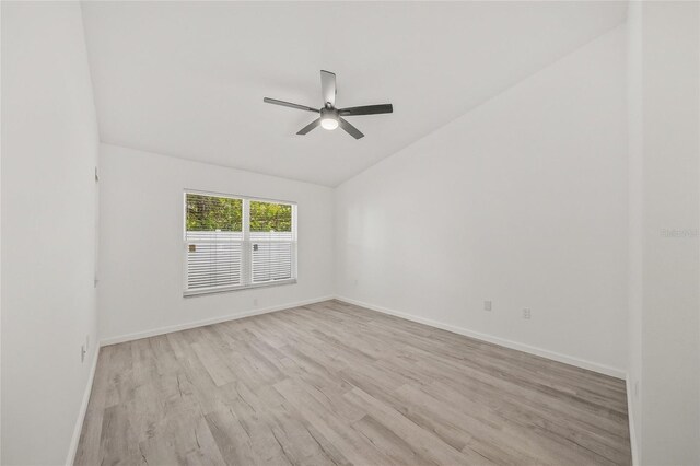 unfurnished room with ceiling fan, vaulted ceiling, and light hardwood / wood-style flooring