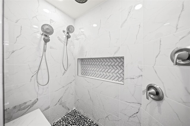 bathroom featuring a tile shower