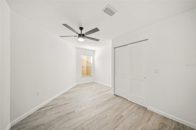 unfurnished bedroom with a closet, ceiling fan, and light wood-type flooring