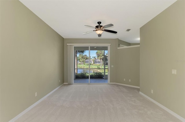 carpeted spare room featuring ceiling fan