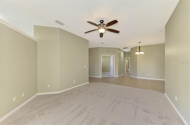 carpeted empty room with ceiling fan with notable chandelier